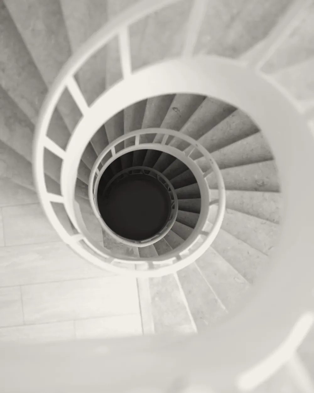 Top view of a black and white spiral staircase with elegant curves and architectural beauty.